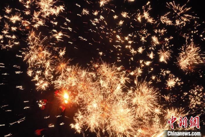 灼熱的鐵水在空中迸散。在空中形成“鐵花火雨”的景象，似天女散花，似群星漫天，如夢如幻，美不勝收。侯奇志 攝</p>
<p>